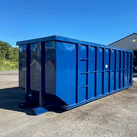 Javi's freshly painted blue 40 yard dumpster on the gravel at the yard